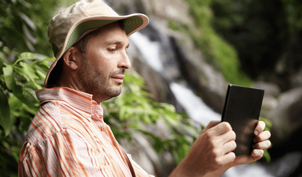 Landscaping employee using a mobile app on-site.