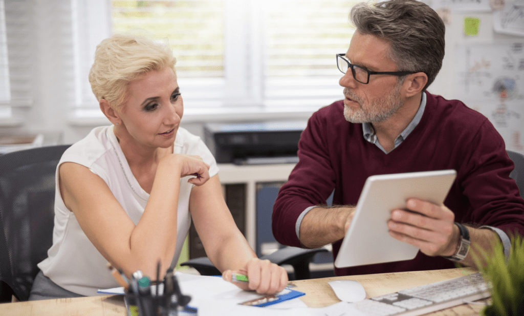 customer getting offered a financing option from a painting business owner using a tablet in a home office