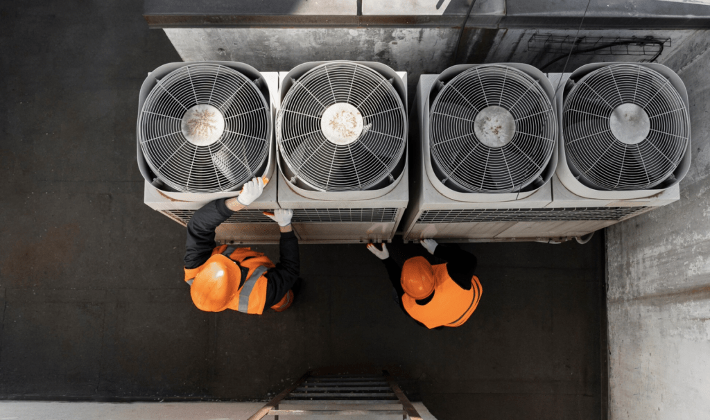 organized labour after HVAC business coaching, two workers on ac units