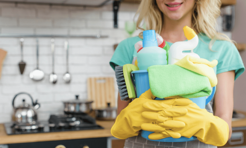 cleaner holding bucket of products and tools 